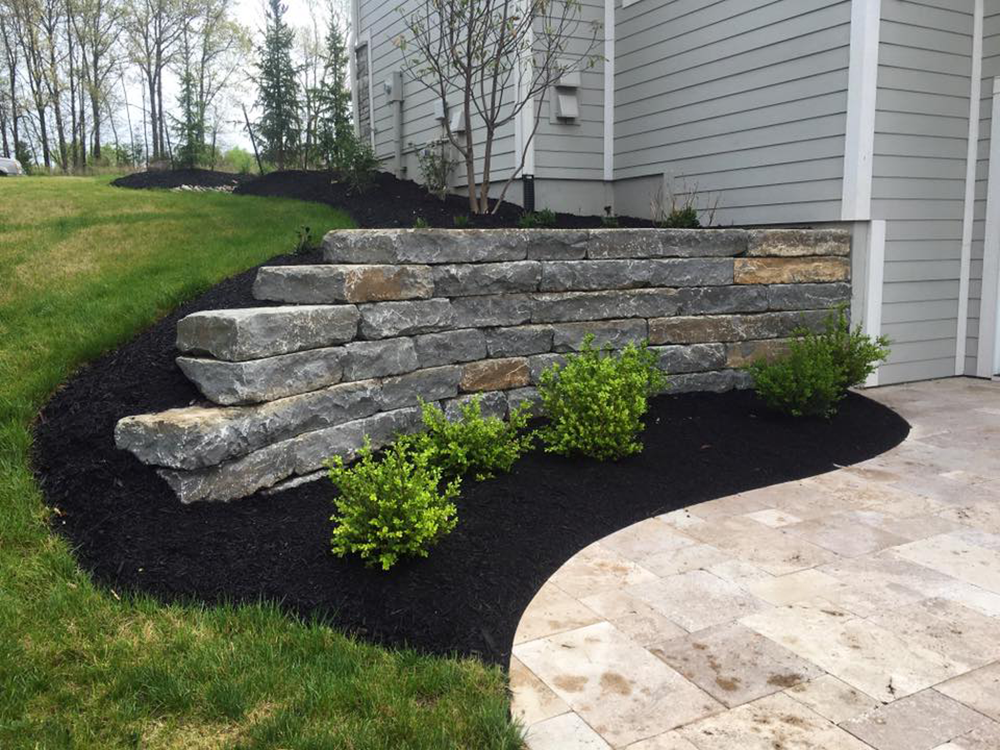Stone retaining wall and landscaping